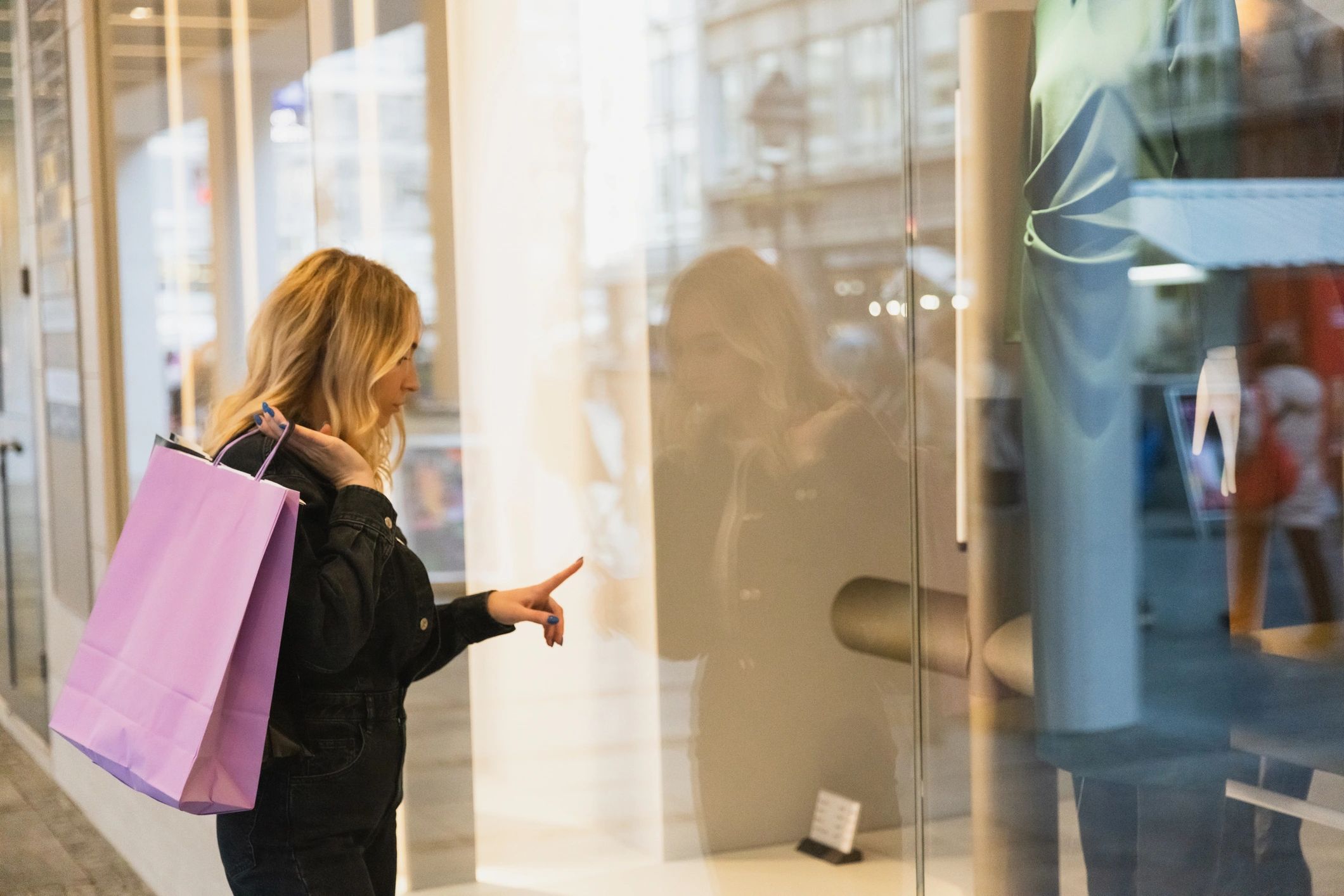 Woman browsing clothing in a boutique storefront