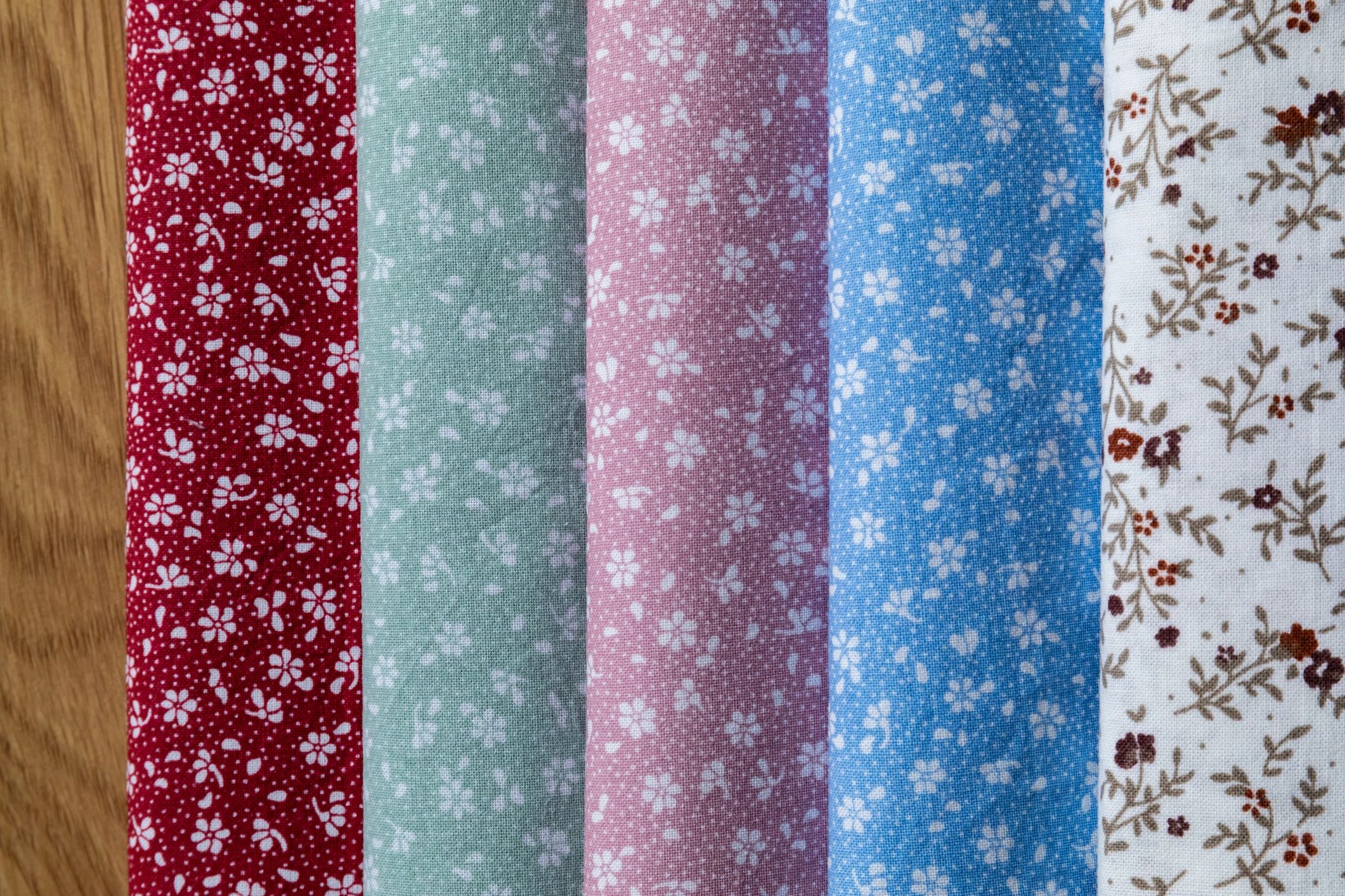 Floral fabrics arranged on a table to reflect boutique style and texture